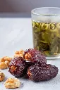 large-date-fruits-medjool-with-walnut-tea-glass-marble-floor3.webp